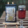 package of herbal tea next to crystal goblet of   red hibiscus tea that has been cold infused