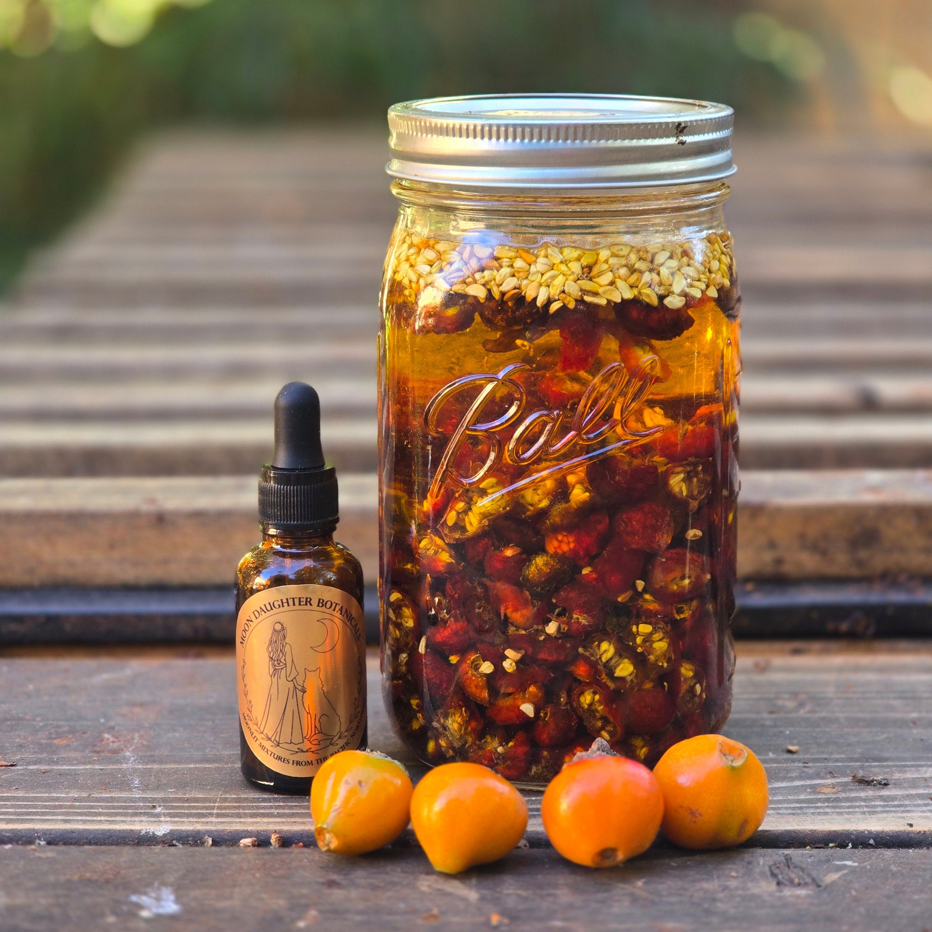 jar of rose hips in oil, next to beautiful serum bottle