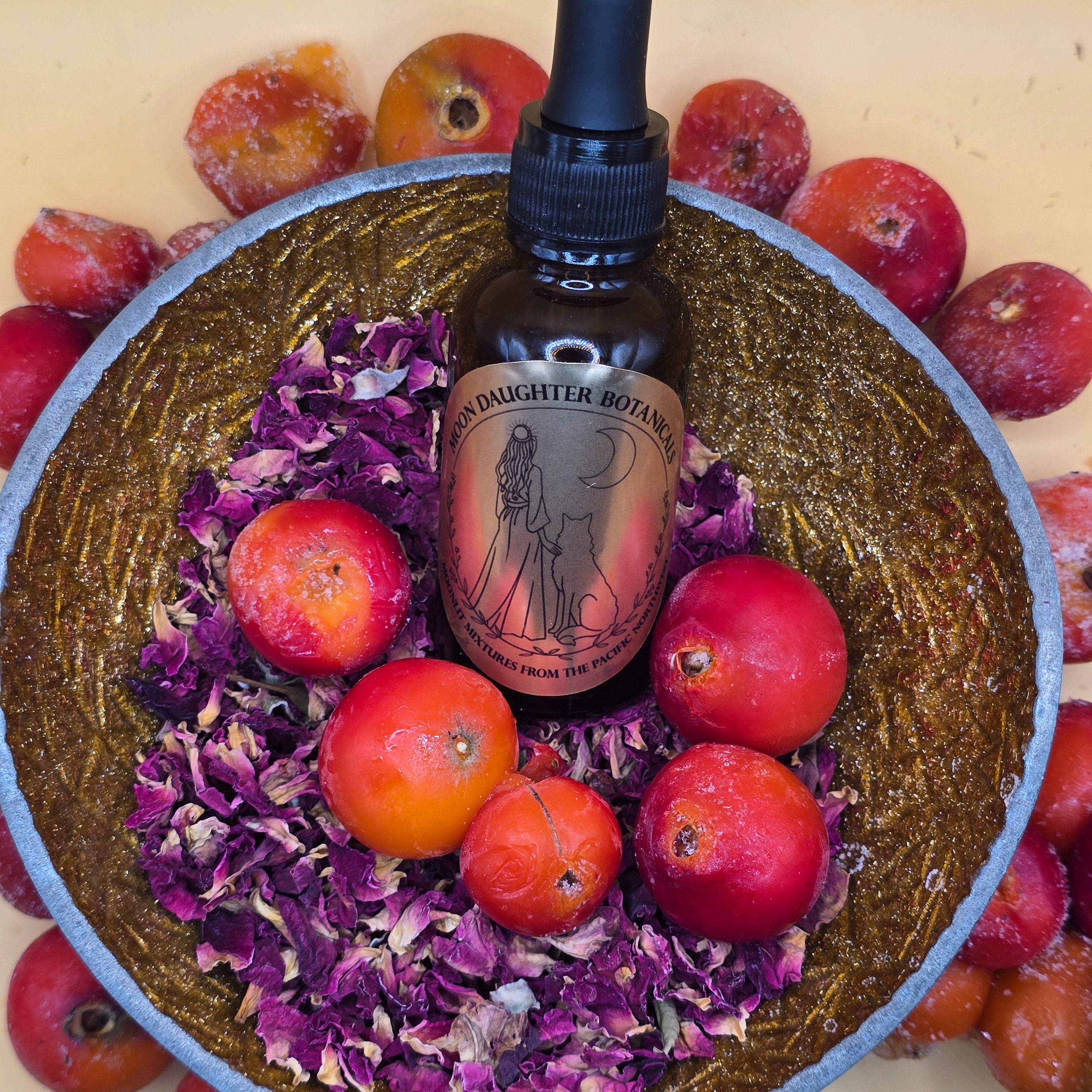 serum bottle of rose hip oil, fresh rose hips in bowl